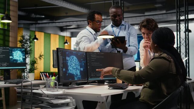 Engineering team in office using AI to optimize company systems performance. Coworkers in startup office use artificial intelligence technology to automate tasks, camera A