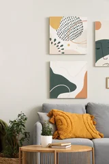 Fotobehang Muziek Cozy sofa with modern pictures and coffee table in living room  © Pixel-Shot