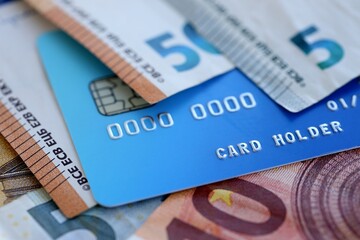 Euro money bills banknotes and credit card for cashless payments. Concept of banking service in European Union countries