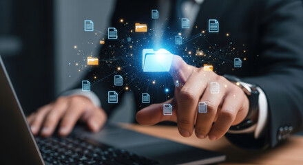 A man interacts with a holographic folder interface on a laptop. He is wearing a suit. The scene is modern and focuses on digital technology and secure data solutions.