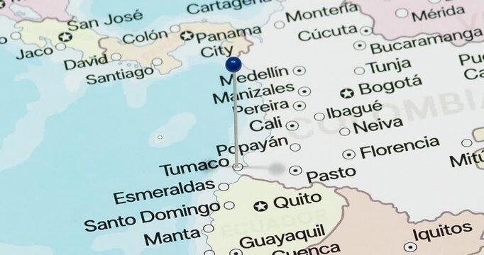 A zoom out of a blue pin into Tumaco city of Colombia political map