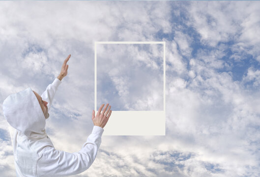 man in white hoodie reaching up towards cloudy sky, cloud dancer, arms outstretched, spiritual connection with nature, ivory pearl wallpaper or digital background for design and product presentation