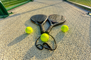 Padel tennis rackets love. Background with copy space. Sport court and ball