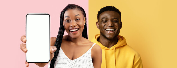 Two cheerful friends pose together, one holding a smartphone and smiling brightly. They stand in a colorful split background with pink and yellow hues, radiating positivity.