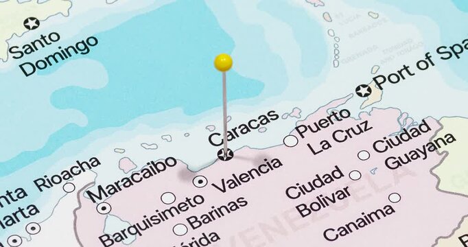 A zoom out of a yellow pin into Caracas city of Venezuela political map