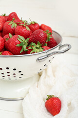Colander with fresh strawberries, closeup