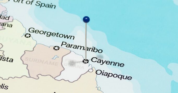 A zoom out of a blue pin into Cayenne city of French Guiana political map