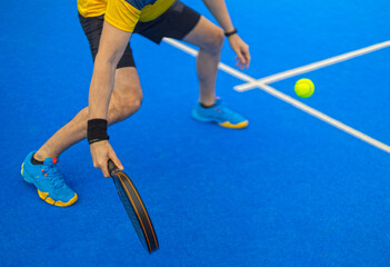 Close-up padel photo. Open Tour template. Padel tennis player on the blue court background outdoors. Paddle tenis template for bookmaker design ads with copy space. Mockup for betting advertisement.