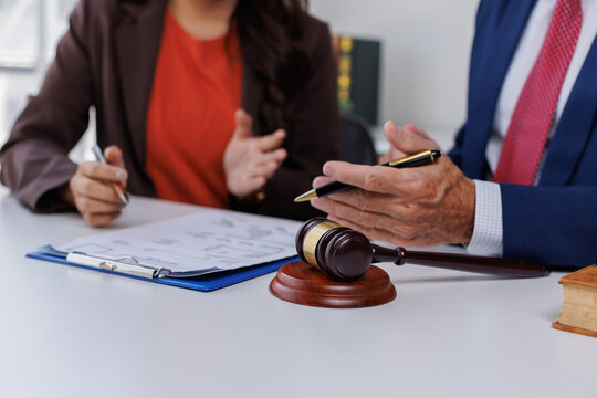 Business and lawyer discuss the contract document. Treaty of the law. Sign a contract business at the lawyer, lawyer meeting concept.
