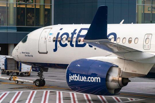 JetBlue Airbus A220 parked at gate at Boston Logan International Airport - Boston, Massachusetts, USA