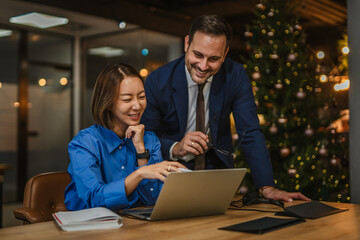 Business colleagues collaborating late in office with manager mentoring