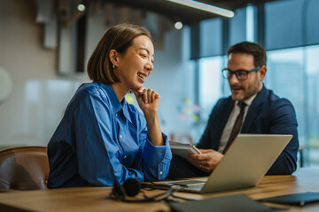 Business colleagues collaborating and discussing ideas in modern office