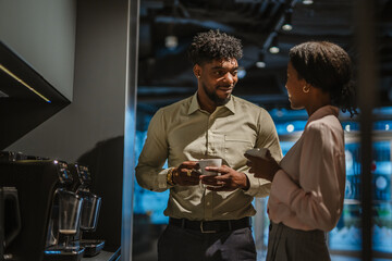 Business professionals having coffee break conversation in office