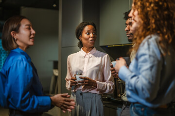 Diverse business colleagues having a casual coffee break discussion