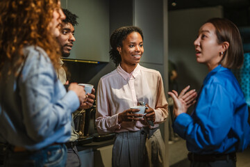 Diverse business colleagues having a casual coffee break discussion
