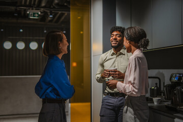 Diverse business colleagues having a casual coffee break conversation