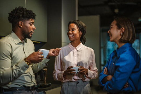 Diverse business colleagues having a casual coffee break conversation - Powered by Adobe