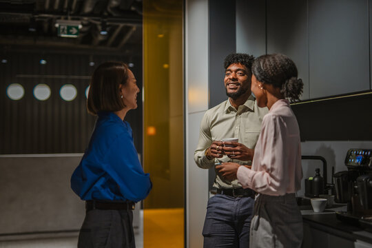 Diverse business colleagues having a casual coffee break conversation - Powered by Adobe