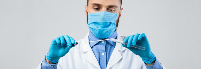 A medical professional in a white coat and blue gloves carefully prepares a sample in a laboratory. He is focused on ensuring accuracy for health testing. The environment is sterile and professional.