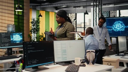 Software developers working in AI startup training predictive models for language processing tasks. Deep learning tech specialists use technical expertise for complex IT requirements, camera A