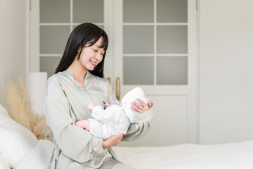 Bedroom, mother holding baby in bedroom (soothing, putting to sleep, childcare)
