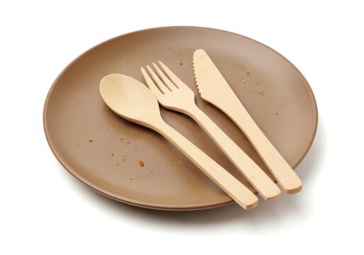 Empty brown plate rests with biodegradable wooden utensils atop a clean white background.