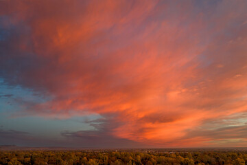 dramatic sunrise cloudscape over Fort Collins and foothills of Rocky Mountains,aerial fall scenery
