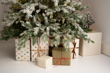 Family gathers around decorated Christmas tree with presents during New Year celebration at home