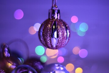 Fototapeta premium Christmas and New Year balls decor for tree and human hand beautiful festive background 