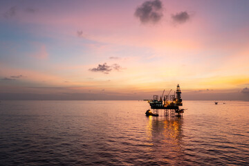 Aerial view of offshore jack up rig in a shipyard during sunset for oil and gas exploration and...