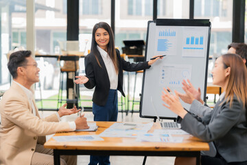 Group of business people discussing business plan in office conference room. Project planning, creative brainstorming, discussing ideas, using documents, digital devices.