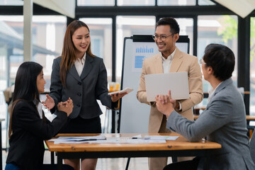 Group of business people discussing business plan in office conference room. Project planning, creative brainstorming, discussing ideas, using documents, digital devices.