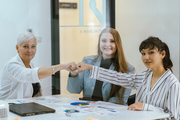 Business team showing unity success with hands together in office, teamwork collaboration and power motivation, diverse colleagues celebrating achievement corporate goal partnership