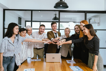Business team showing unity success with hands together in office, teamwork collaboration and power motivation, diverse colleagues celebrating achievement corporate goal partnership