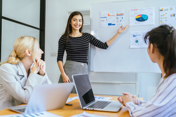 Business team analyzing data and marketing strategy in modern office, brainstorming ideas for project success using laptops and charts, teamwork collaboration for corporate growth