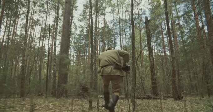 Reenactor Dressed As Russian Soviet Infantry Soldier Of World War Ii Run With Rifle Mosin Nagant. War Combat In Forest. Reenactment Tactic Game. Red Soviet Army Military Uniform