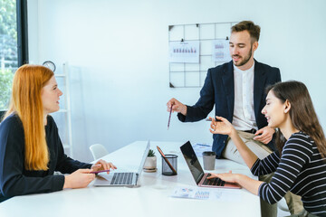 Business team analyzing data and marketing strategy in modern office, brainstorming ideas for project success using laptops and charts, teamwork collaboration for corporate growth