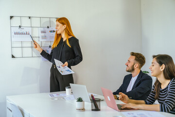 Business team analyzing data and marketing strategy in modern office, brainstorming ideas for project success using laptops and charts, teamwork collaboration for corporate growth