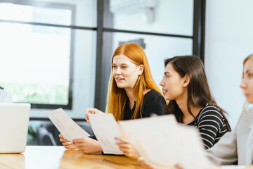 Business team analyzing data and marketing strategy in modern office, brainstorming ideas for project success using laptops and charts, teamwork collaboration for corporate growth