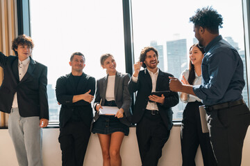 Professional business team having meeting discussing corporate strategy and project results using laptop in modern city environment showing teamwork leadership confident collaboration spirit