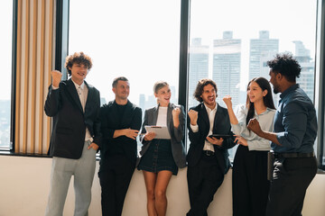 Professional business team having meeting discussing corporate strategy and project results using laptop in modern city environment showing teamwork leadership confident collaboration spirit