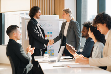 Professional business team having meeting discussing corporate strategy and project results using laptop in modern city environment showing teamwork leadership confident collaboration spirit