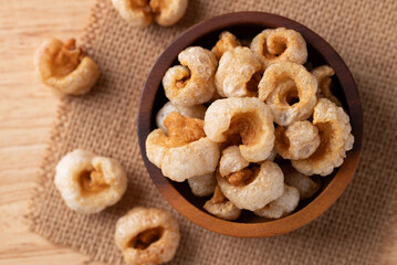 Pork rind in a wooden bowl, Northern Thai food, Table top view