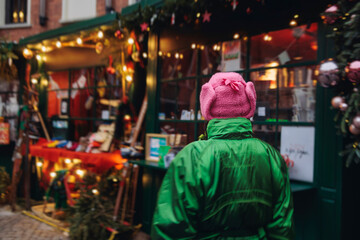 Obraz premium Christmas market with illuminated food stalls, gift shops and kiosks, New Year outdoor fair decorations, garlands and festoons, Xmas atmosphere, retail and store illumination, decor in Europe city