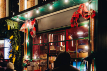 Obraz premium Christmas market with illuminated food stalls, gift shops and kiosks, New Year outdoor fair decorations, garlands and festoons, Xmas atmosphere, retail and store illumination, decor in Europe city