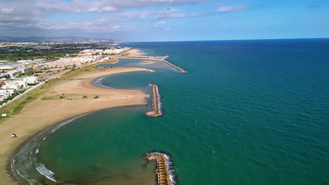 4K Aerial cinematic view of Cunit beach and Mediterranean Sea coastline in Catalonia, Spain. Wide sandy beach, turquoise water and summer vacation atmosphere.
