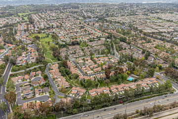 Fullerton, Orange County, CA, California, April 25, 2024: Aerial Drone City View toward Emery Park, Cypress Point Dr, Malvern Ave, Burning Tree Rd with Homes, Houses, Townhouses, Streets, Roads, Parks