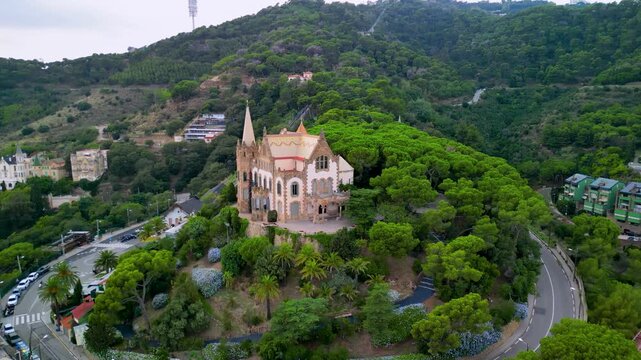 Epic Barcelona fairy castle aerial orbit. 
Cinematic 4K drone panorama of historic 
modernist Casa Arnus palace and historic 
funicular railway on Tibidabo hill.
