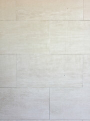 Fototapeta premium Full frame background texture of a light beige travertine stone wall with a rectangular block pattern.