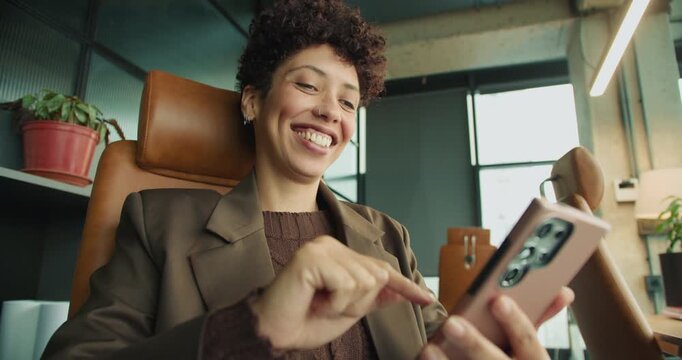 Cheerful female enjoying content creation in lively workspace